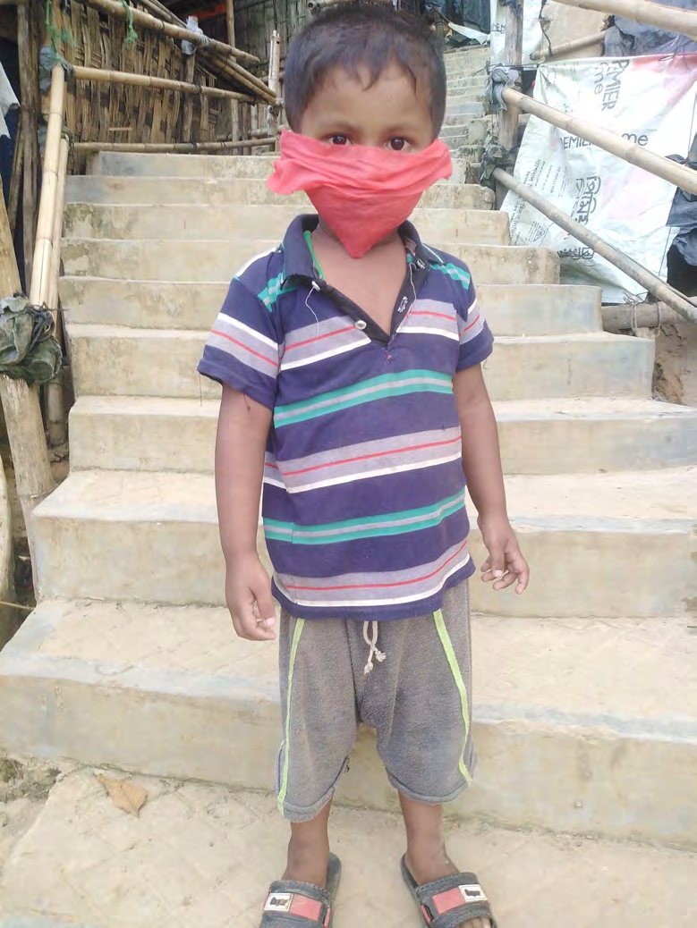 A young boy with a makeshift face mask in Camp-5